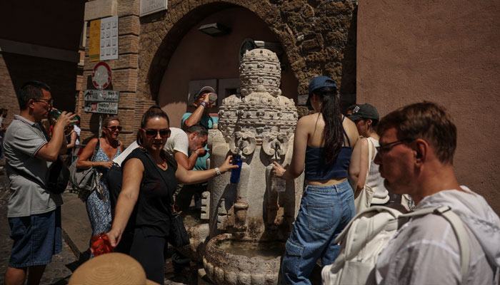 People fill their bottles with water from a fountain during a heatwave, in Rome, Italy, July 23, 2025. — Reuters