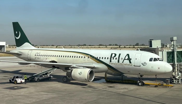 View of a PIA passenger plane, taken through a glass panel, at Islamabad International Airport, on October 3, 2023. — Reuters