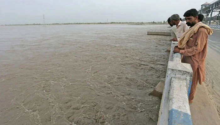 Commuters watch overflowing River Sutlej at Islam Headworks in Hasilpur, in Punjab on August 26, 2023. — AFP/File