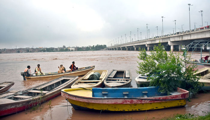 A view of rising floodwaters in the Ravi River passing under the bridge, as local authorities issue alerts urging residents to adopt safety measures on September 1, 2025. — APP