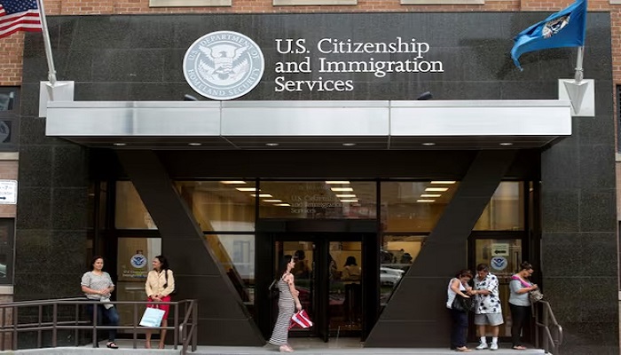 FILE PHOTO - People stand on the steps of the US Citizenship and Immigration Services offices in New York, US on August 15, 2012. — Reuters