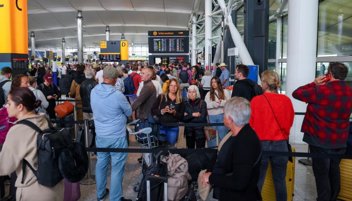 Travellers wait near a check-in area at Heathrow Airport Terminal 2, amid flight delays and cancellations, resulting from a disruption to check-in and boarding systems caused by a cyberattack which has affected several major European airports, in Greater London, Britain, September 20, 2025 — Reuters