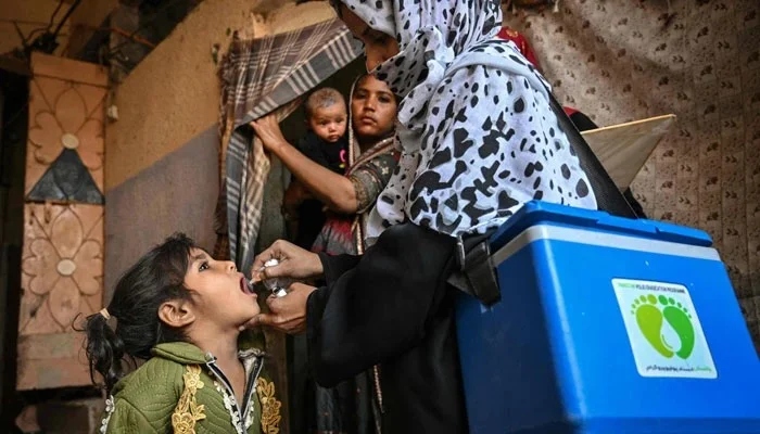 A health worker administers polio drops to a child on the first day of a nationwide polio vaccination campaign, in Karachi on February 3, 2025. — AFP