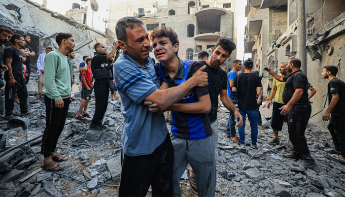 People react as Palestinian civil defence members and others search for survivors after houses were bombed by Israeli forces in Khan Younis, Gaza. — AFP/File