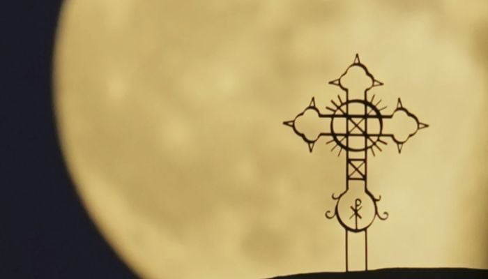 he Harvest Supermoon rises behind the cross of ‘Metamorphosis Sotiros’ Christian Orthodox Church at Anthoupolis capital Nicosia, Cyprus