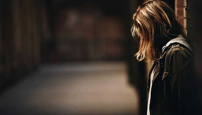 This representational image shows a woman standing alone. — Unsplash