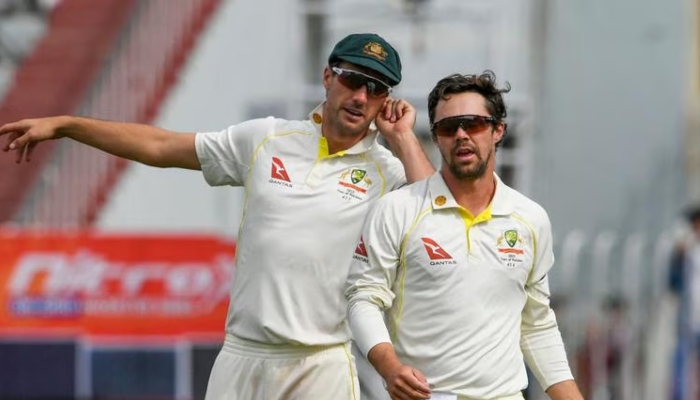 Australias captain Pat Cummins (left) speaks with Travis Head during the fifth day of the first Test between Pakistan and Australia at the Rawalpindi Cricket Stadium on March 8, 2022. — AFP