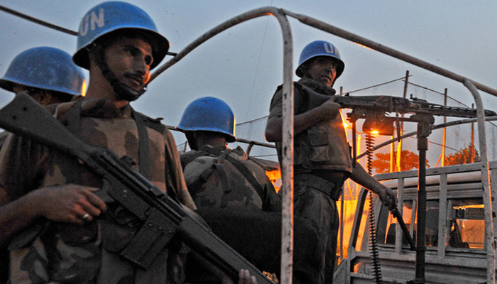 Pakistani UN peacekeepers patrol near the United Nations force in Ivory Coast (ONUCI) headquarters on December 31, 2010 in Abidjan. — AFP