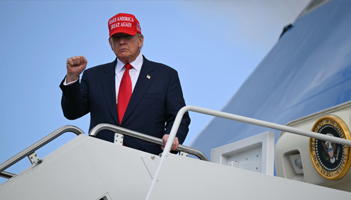 US President Donald Trump gestures to the press as he steps off Air Force One upon arrival at Joint Base Andrews in Maryland on October 30, 2025. — Reuters