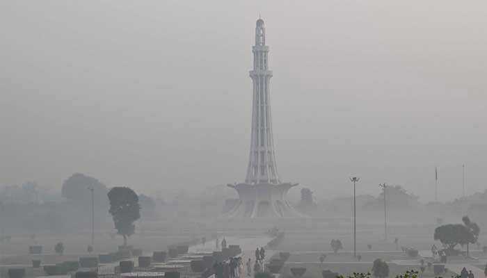 People visit a park amid heavy smoggy conditions in Lahore on October 26, 2025. — AFP