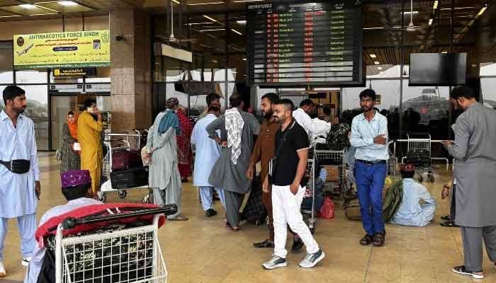 Passengers wait outside at Jinnah International Airport after all domestic and international flights were cancelled in Karachi, Pakistan, May 7, 2025. — AFP