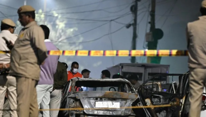 Indian security personnel stand beside charred vehicles at the blast site after an explosion near the Red Fort in the old quarters of Delhi, November 10, 2025. — AFP