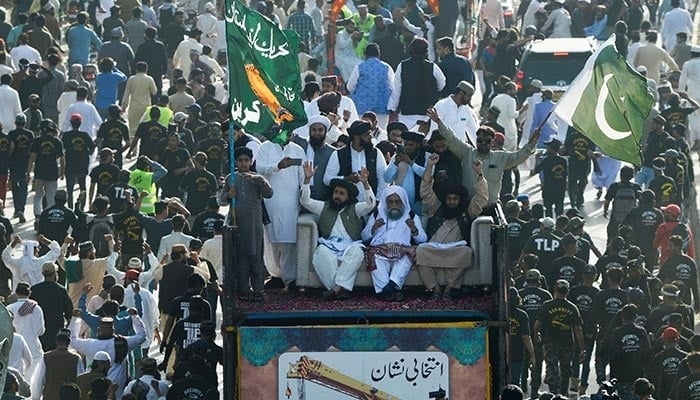 Saad Hussain Rizvi, leader of banned Tehreek-e-Labbaik Pakistan (TLP), waves to supporters during a protest against the hike in price of essential commodities in Karachi. — AFP/File