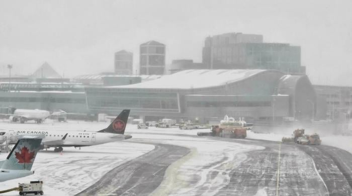 Toronto Pearson airport cancellations spike as snowstorm hits YYZ and YTZ