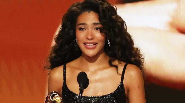 Olivia Dean fights back tears after winning first Grammy Award