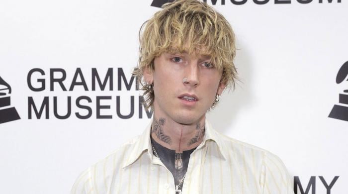 Machine Gun Kelly unveils new ear ink at Grammys pre-party