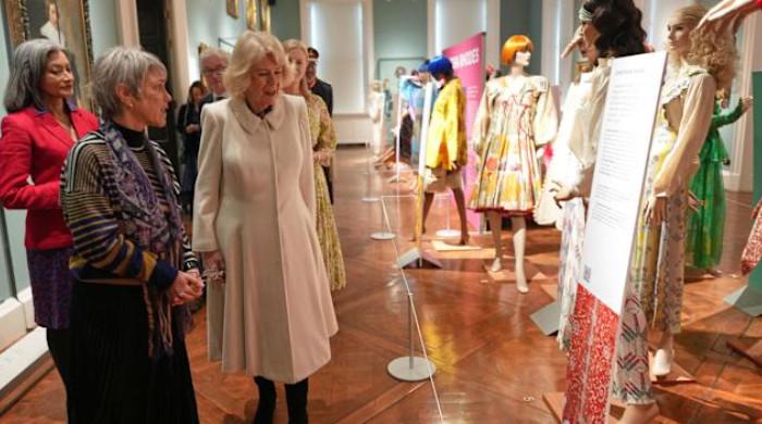 Queen Camilla tours special exhibit for historic fashion show