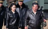 North Korean leader Kim Jong Un shares rare public moment with daughter on tank ride during military display 