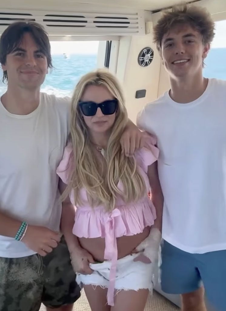 Britney standing with her sons Sean and Jaden