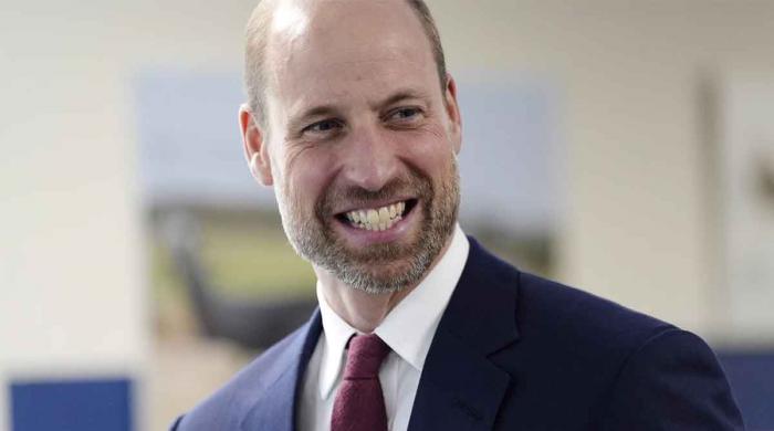 Prince William pilots boat during royal visit
