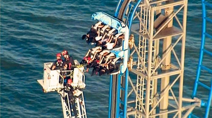 Watch how firefighters saved riders stuck dangling on roller coaster over 100 feet in Texas