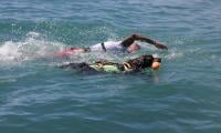 Dramatic rescue as hero dog battles rough waves for 30 minutes at sea 