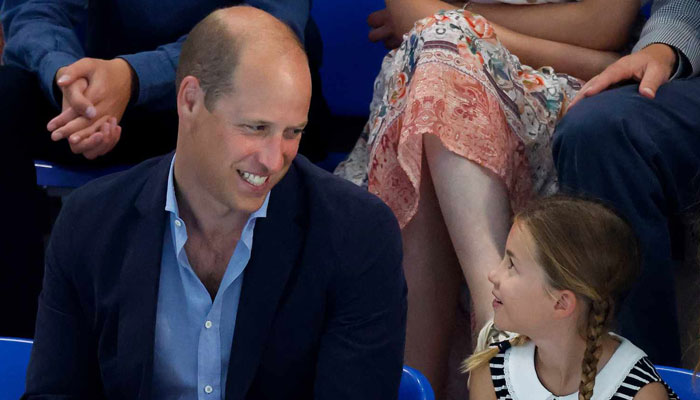 Princess Charlotte turns up in a white dress beside smiling Prince William