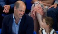 Princess Charlotte turns up in a white dress beside smiling Prince William