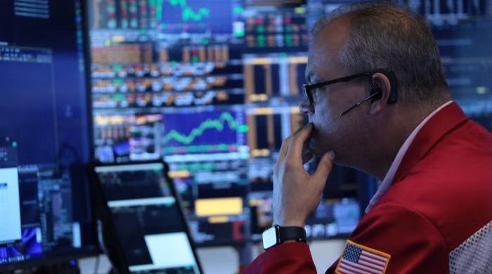 Global stock markets fall as AI chip stocks slide and oil rises