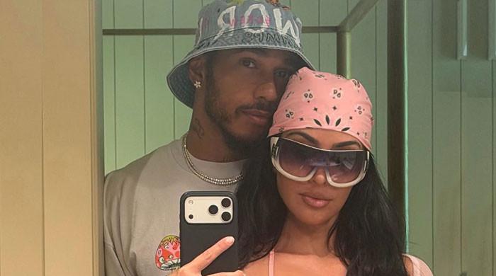Kim Kardashian shares loved up beach moment with beau Lewis Hamilton