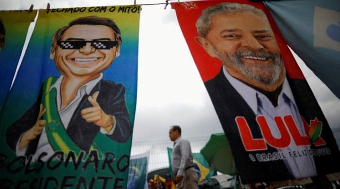 Brazil votes in tight race between Bolsonaro and Lula as polls close